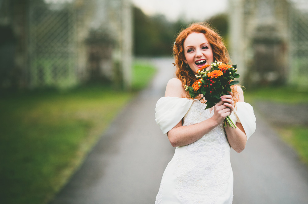 Bridal model Ivory Flame laughing in wedding dress by photographer Aaron Storry