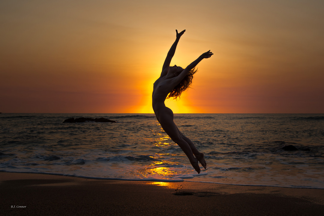 Art Nude Model Ivory Flame silhouette jumping at sunrise by photographer Brian Connor in Australia
